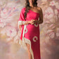 Model poses in front view wearing a pink one-shoulder georgette dress featuring shell-detailed embroidery and fringe hem, styled for a beach vacation or party night.