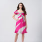 Model wearing a short pink and white chinon dress with twisted neckline and puff sleeves, standing front-facing.