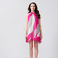 Model facing forward in a pink and white abstract chiffon dress with halter neckline and short hem.