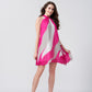 Model walking in side-forward pose, highlighting the dress’s flow and playful movement.