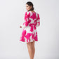 Angled shot of the model in pink and white floral dress, showcasing the silhouette and sleeve volume.