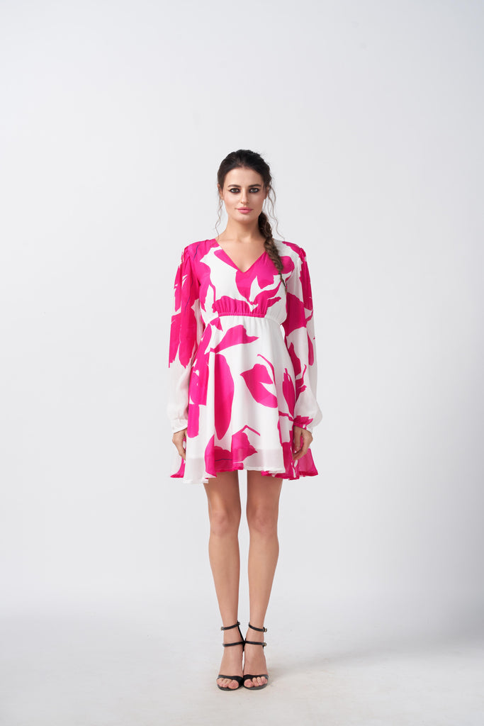 Model standing front-facing in pink and white floral short dress with balloon sleeves and V-neckline.