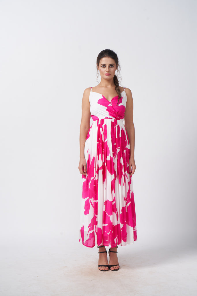 Model facing front in a pink and white floral ankle-length dress with spaghetti straps and gathered flare.