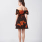 Short abstract print crepe dress in warm orange and brown tones, ideal for daytime gatherings and relaxed social events