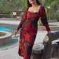 Ankle-length chinon dress with an overlapped neckline, long sleeves, and an orange and black abstract floral print, designed for stylish daytime events and elegant evening occasions.