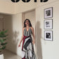 Plus-size striped maxi dress styled for cocktail evenings and festive celebrations