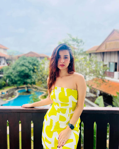 Yellow printed tube dress with an elasticated strapless neckline and sculpted fit