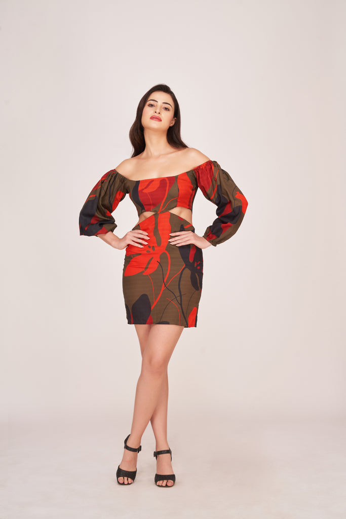 Model wearing a puff long sleeve satin mini dress with green base and red-black floral print, posing front-facing with hands on hips.