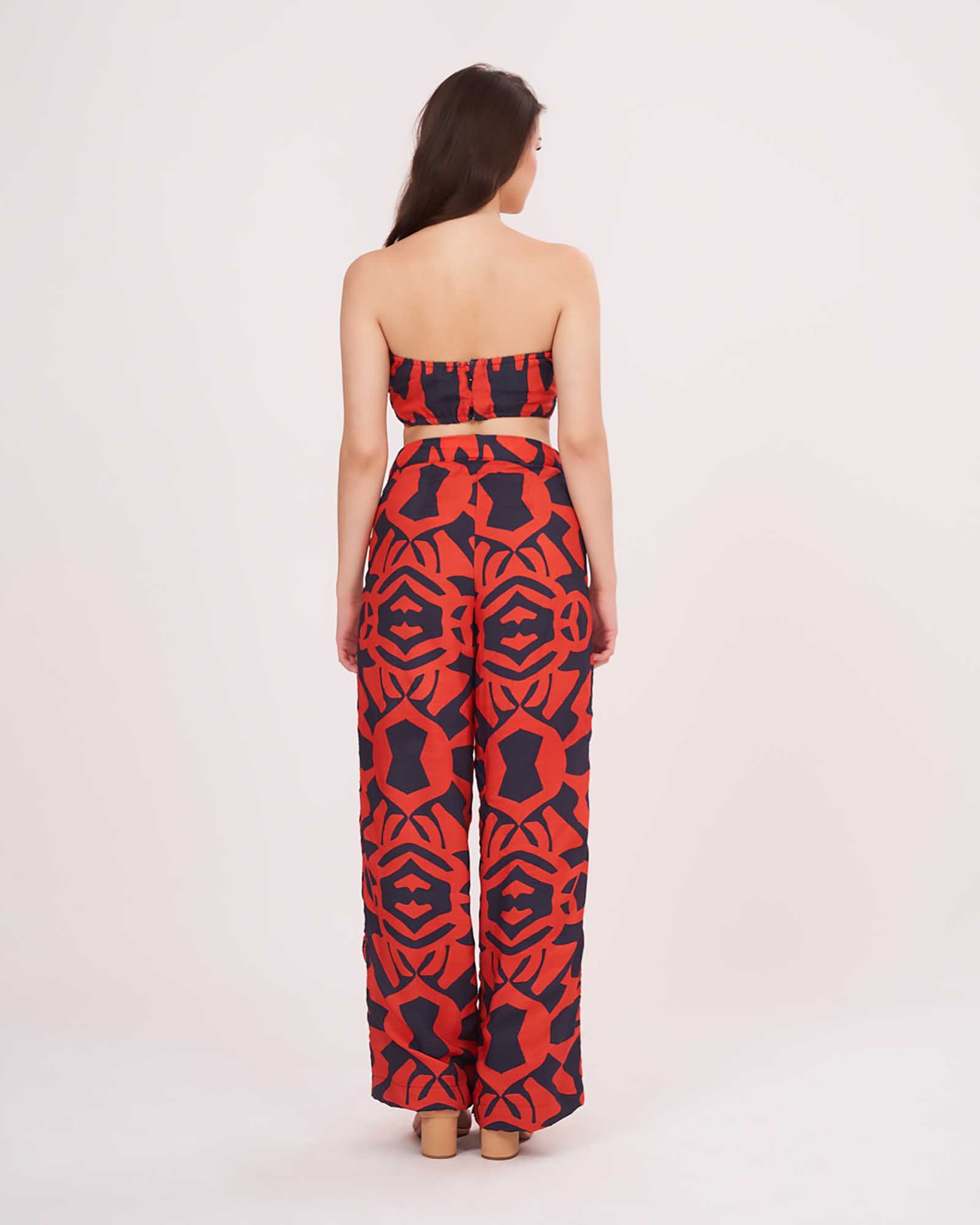 Back view of printed co-ord set showing back hook closure crop top and relaxed muslin pants with bold multicolor pattern.