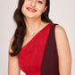 Mid-shot of the model smiling in a red and brown one-shoulder dress, highlighting the neckline and waist cut-out.
