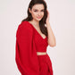Side view of model turning slightly with one arm relaxed, showing the drape and flow of the mini skirt and the structured cut of the single sleeve top.