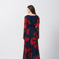 Rear view of red and navy abstract floral print dress showing the flowy back silhouette.