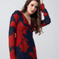 Close up view of the model highlighting movement and flow of the long-sleeved red floral dress.