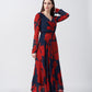 Front-facing view of model in red and navy abstract print ankle-length chinon dress with overlapped V-neck.