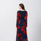 Back view of an ankle-length chinon dress with long sleeves and a flowing fit