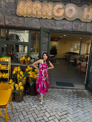 Resort-ready floral midi dress with tie-up straps and flowing pleated waist