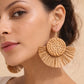 Brown rattan drop earrings with a woven round centre and fan-shaped drop, styled for everyday and casual occasion wear.