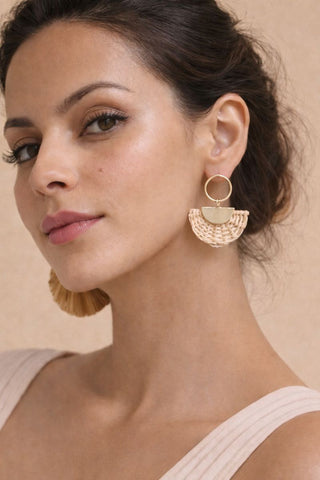 Boho woven rattan fan earrings with a gold hoop post, styled on a model for a chic summer or tropical look.