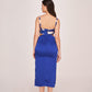 Rear studio view of model wearing blue satin dress, displaying back zip and shoulder straps.