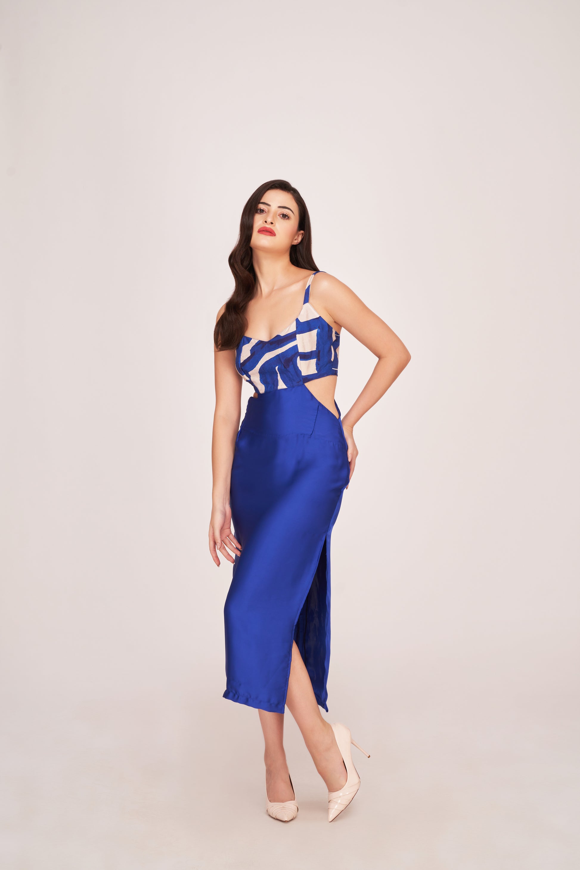 model in blue satin dress, showcasing V-neckline and shoulder strap detail.