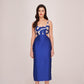 Model in royal blue satin midi dress with abstract white print, posing front-facing in studio.