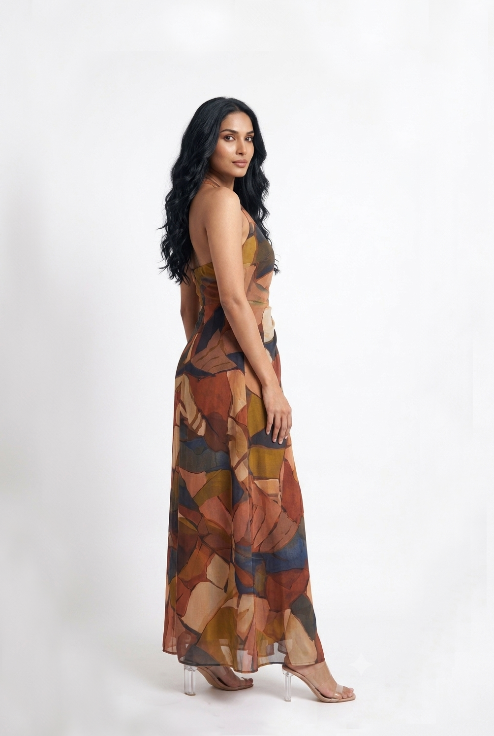 Sophisticated halter neck maxi dress with a softly draped waist and graceful silhouette, perfect for sunset soirées and festive evening celebrations.