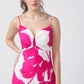 Close-up of the ruched front bodice and neckline of the pink floral dress.
