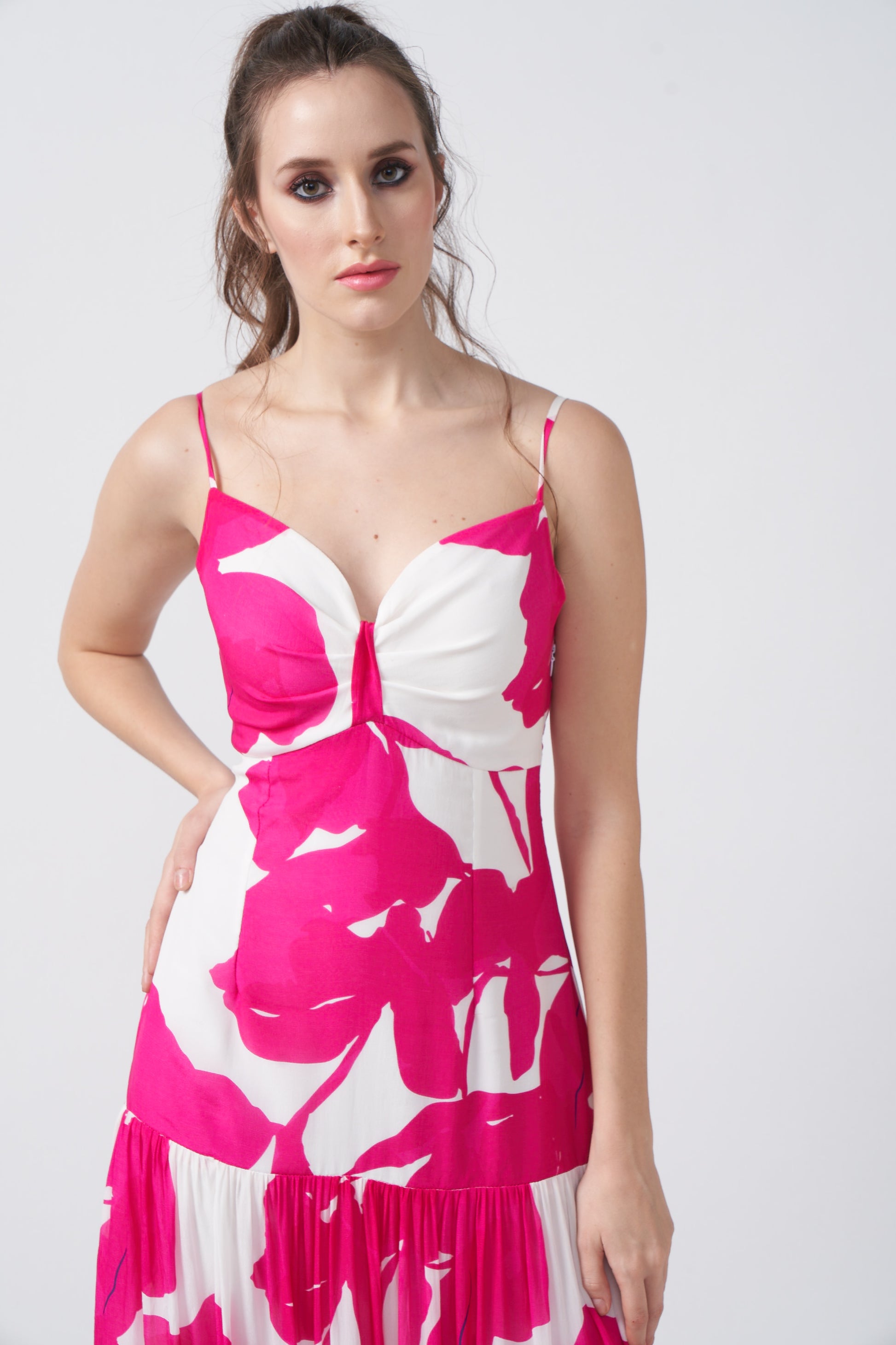 Close-up of the ruched front bodice and neckline of the pink floral dress.