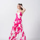 Side profile showcasing the silhouette and flow of the ruched pink floral dress.
