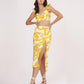 Floral yellow muslin co-ord set, highlighting the thigh-high slit and fitted silhouette