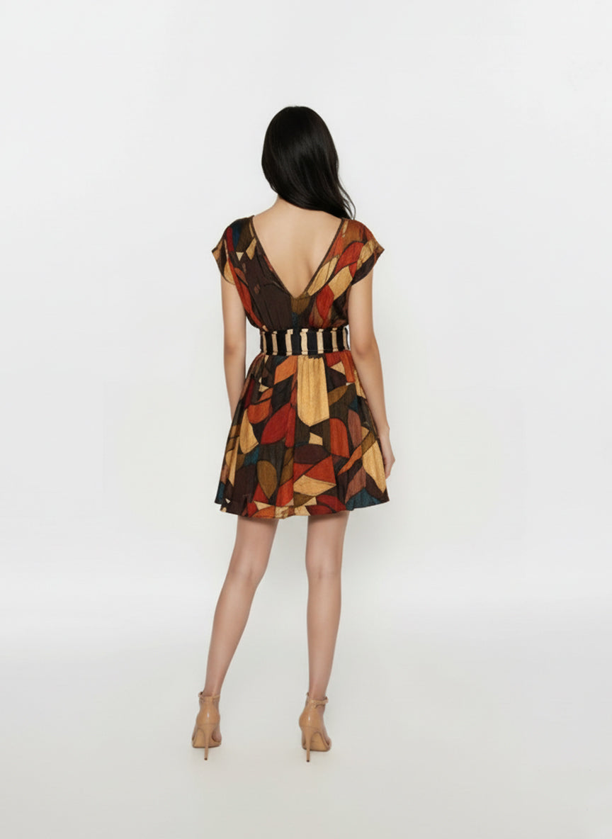 Back view of Mini V-neck dress featuring a striped waistband and geometric abstract print in warm earthy tones