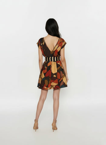 Back view of Mini V-neck dress featuring a striped waistband and geometric abstract print in warm earthy tones