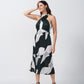 Walking pose of model highlighting the fluidity of the abstract print satin midi dress.
