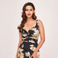 model in a black ankle-length floral dress, showing the twisted neckline and flattering silhouette.
