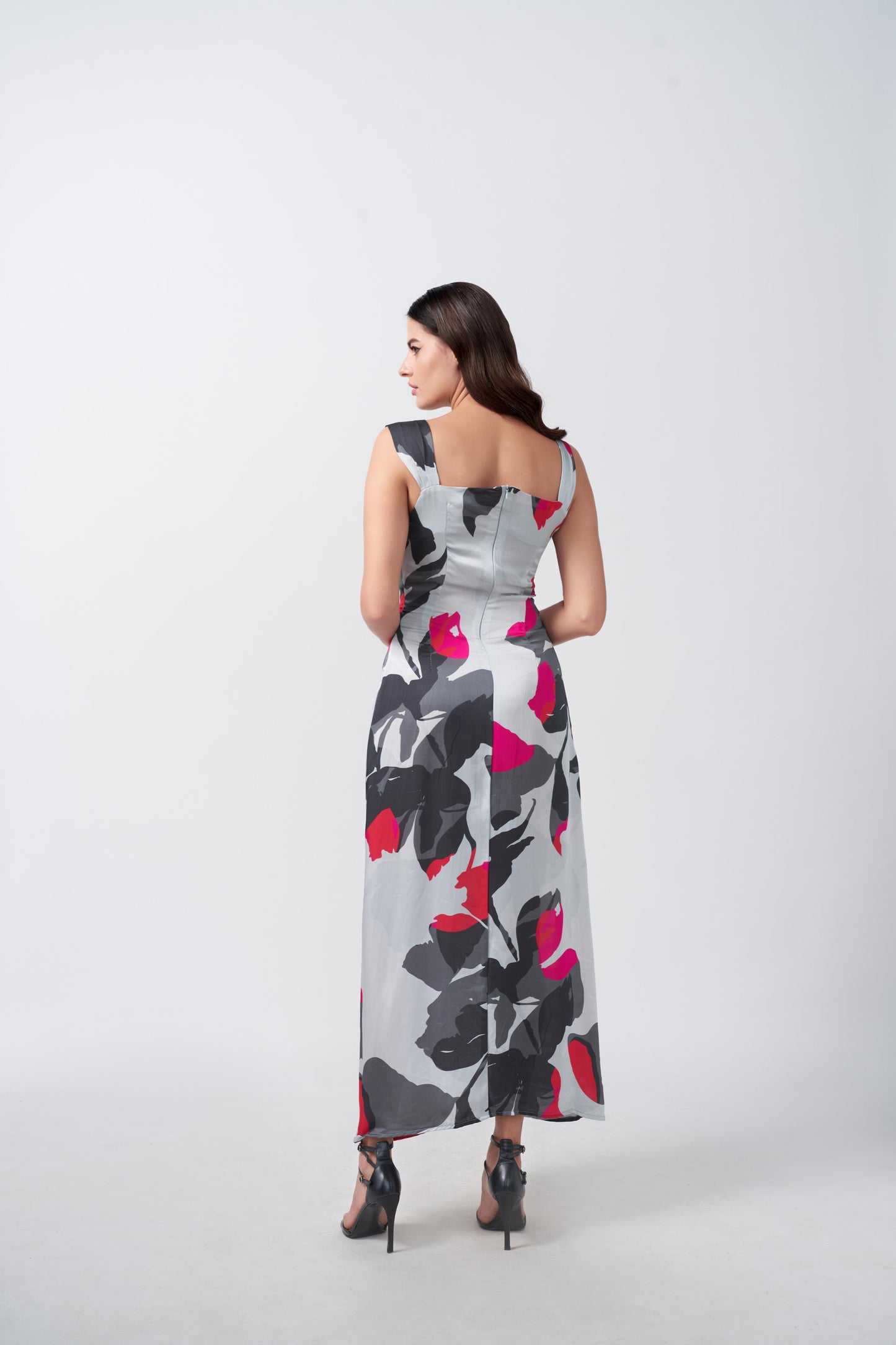 Rear view of grey and white floral print satin dress showing back silhouette.
