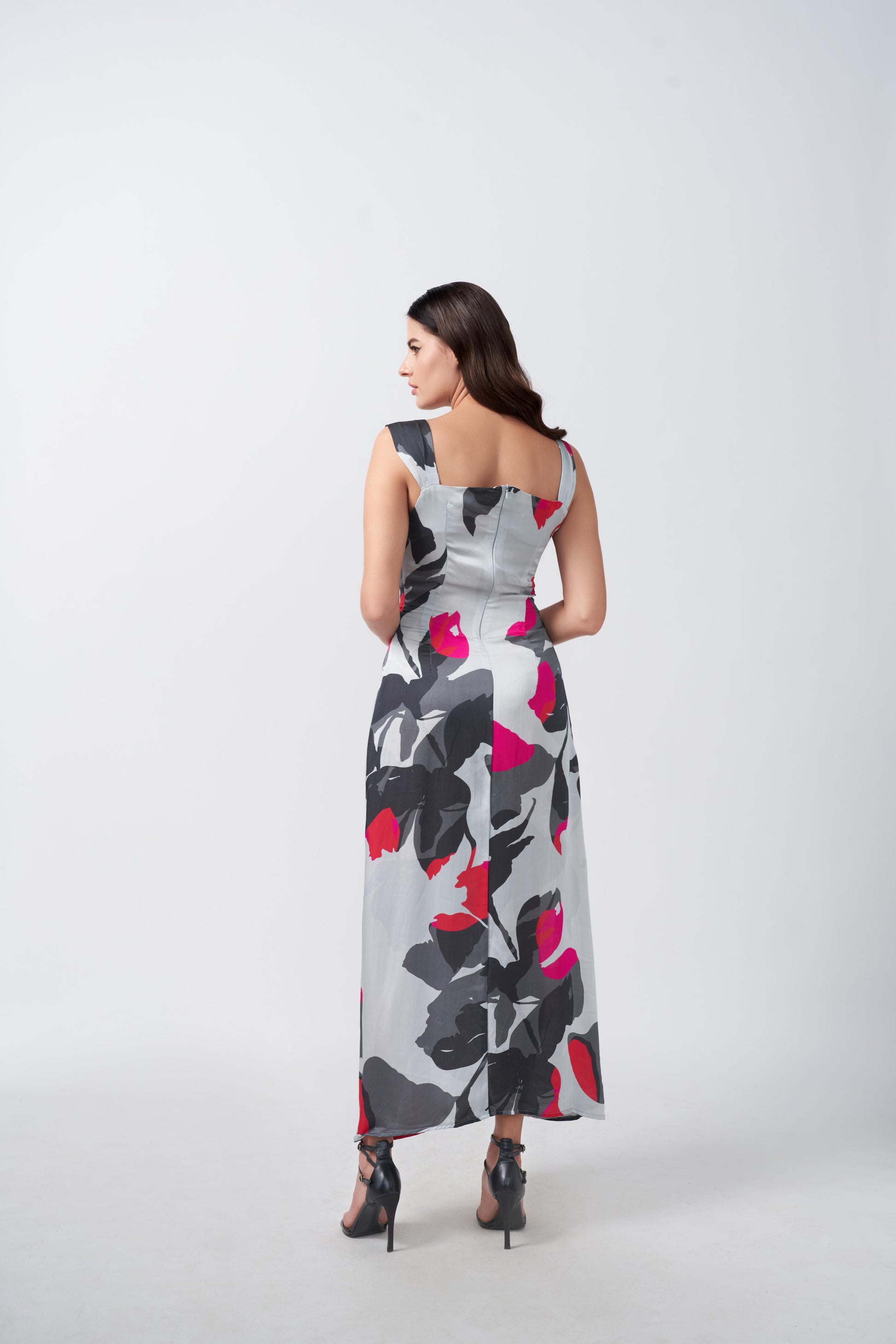 Rear view of grey and white floral print satin dress showing back silhouette.
