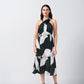 Front-facing view of model in dark green, grey, and black abstract satin midi dress.