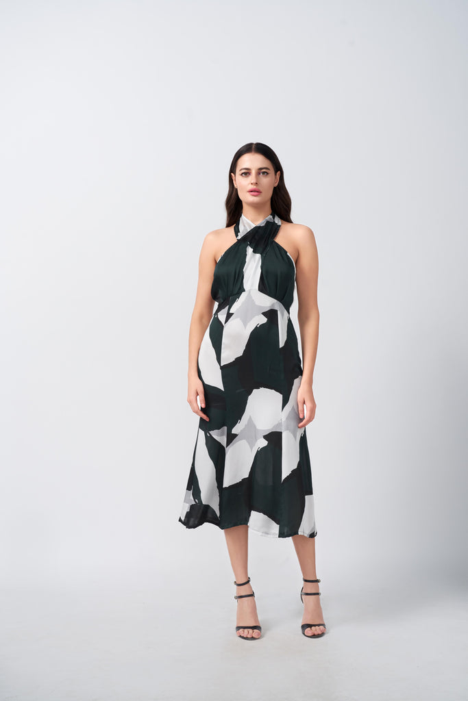 Front-facing view of model in dark green, grey, and black abstract satin midi dress.