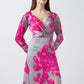 Front view of the model in a satin pink and grey floral dress with overlapped V-neck and elegant full sleeves.