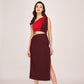 Model walking forward in red and brown crepe panelled dress, showing high slit and body-hugging fit.