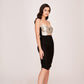Side view of the model in a strap-shoulder satin dress featuring silver bodice and black ruched skirt.
