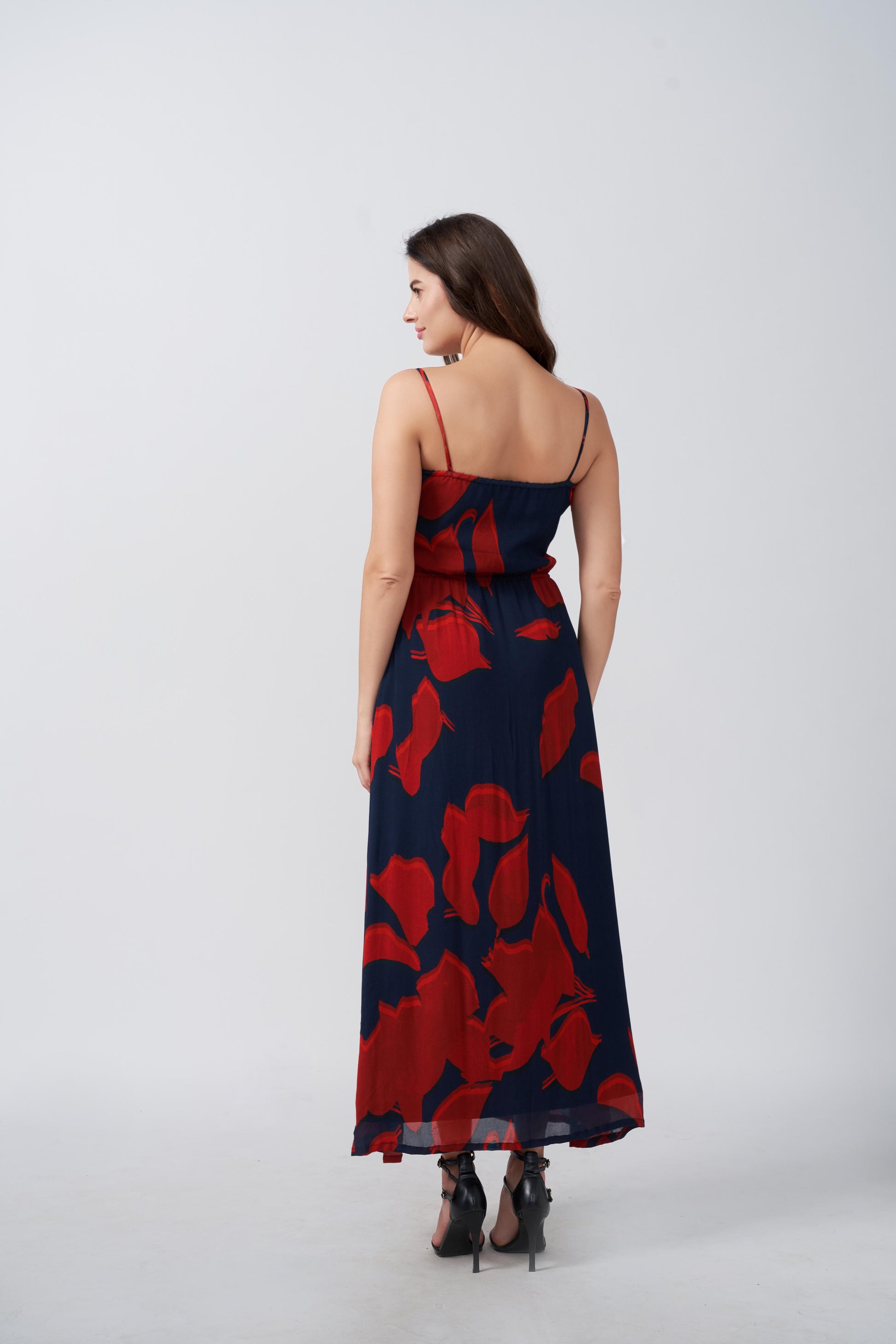 Rear view of the dress showcasing back tie and silhouette in red and navy floral print.