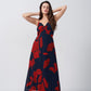 Front view of model in red and navy ankle-length chinon dress with spaghetti straps and ruched front.