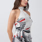 Close-up of model in grey and red floral satin wrap dress, highlighting halter neckline and wrap detailing.