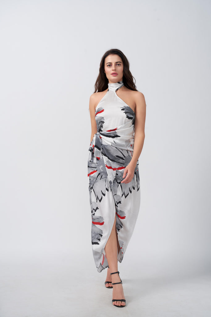 Model wearing a grey floral satin wrap dress with halter tie-back neck, standing in front-facing pose.