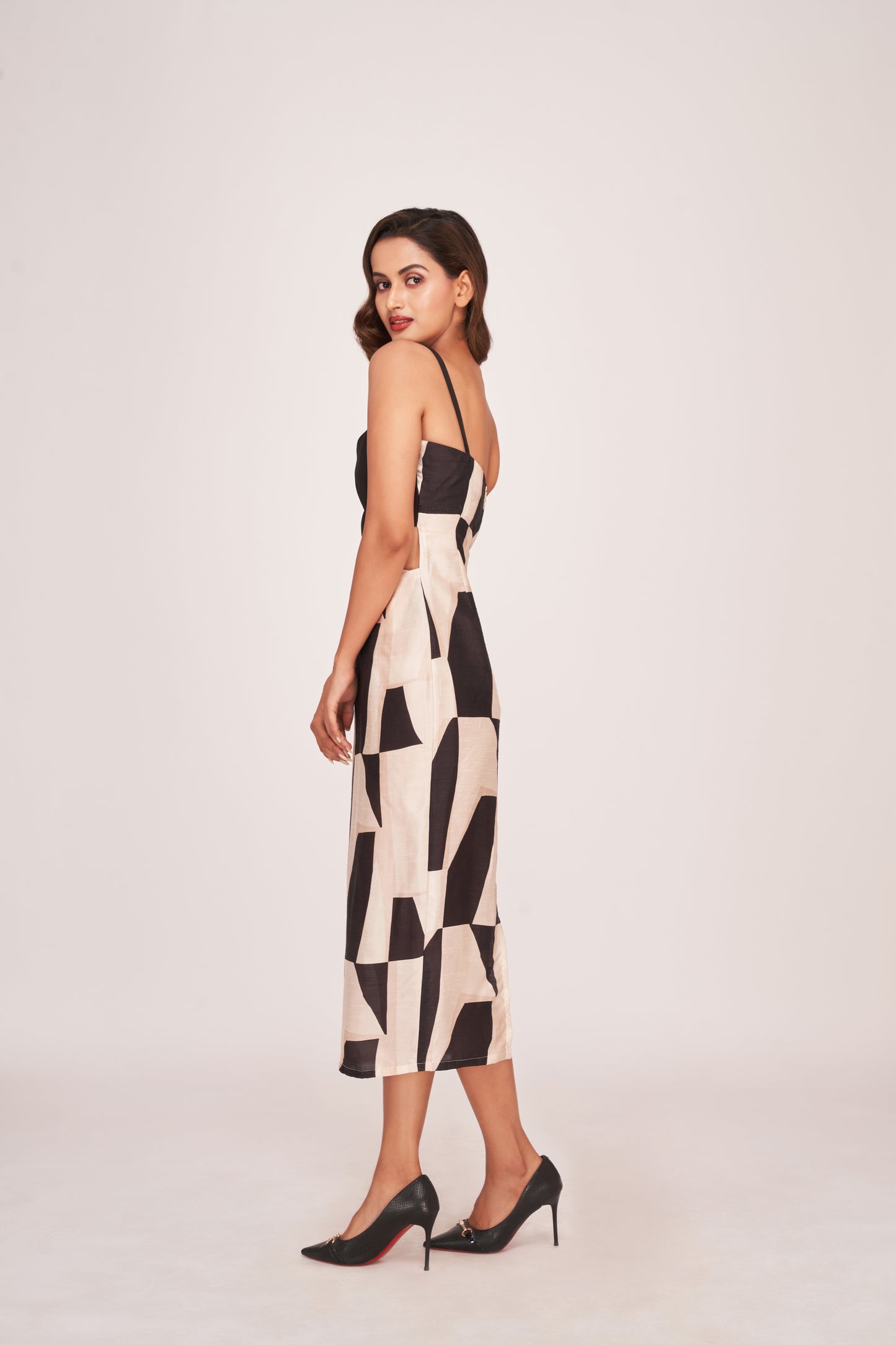 Side view of the dress highlighting the form-fitting cut, side slit, and elegant abstract pattern.