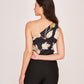Side profile view of the black floral one-shoulder co-ord set, highlighting the soft drape of the satin fabric and the sculpted silhouette.