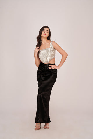 A glamorous co-ord set featuring a shimmering silver square-neck corset top paired with a floor-length black skirt, creating a sophisticated evening silhouette.