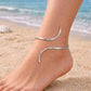This silver anklet offers a bold and contemporary silhouette, designed to effortlessly elevate your vacation wardrobe or add a refined edge to your favorite pair of heels.