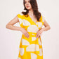 Yellow printed cotton satin wrap dress, suitable for vacations and daytime outings